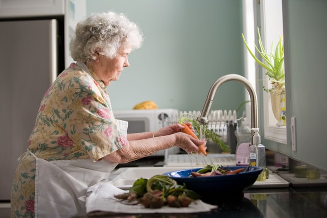 Women at sink washing veggies